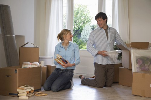 Movers carrying furniture safely through a home hallway