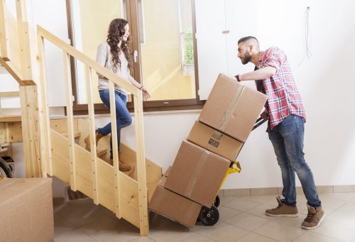 Staff using PPE and secure lifting methods during a van loading process