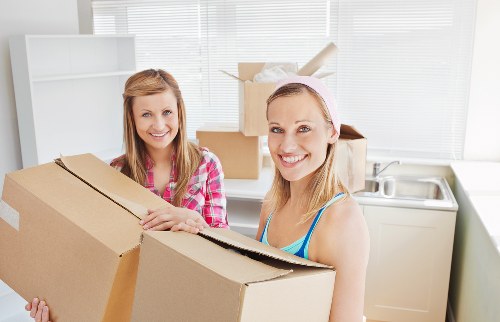 A local moving team packing items in a property with limited access